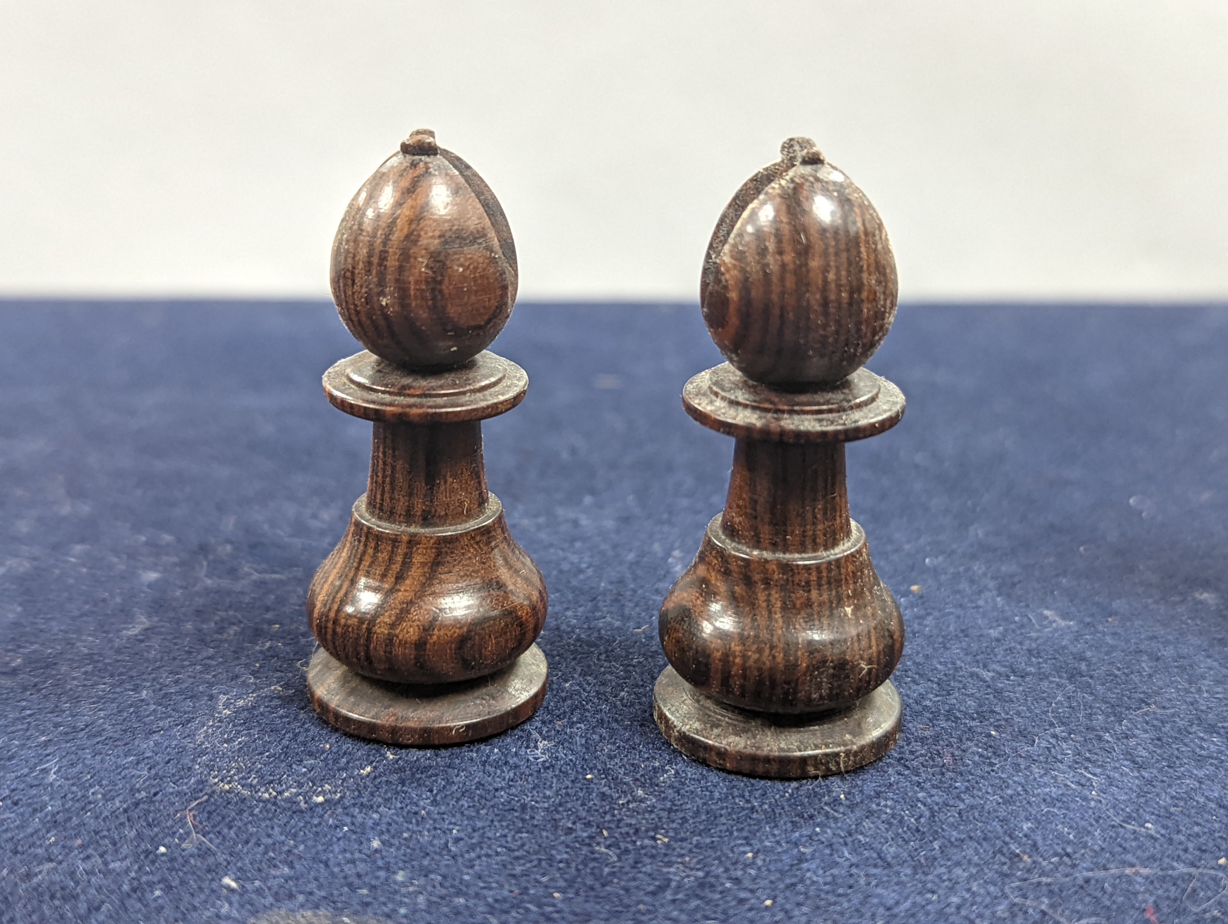 A Victorian brass inset mahogany games box, fitted with solitaire, cribbage, chessmen, draughts etc., 33cm, a turned and stained bone chess set, another games box containing chessmen and draughts